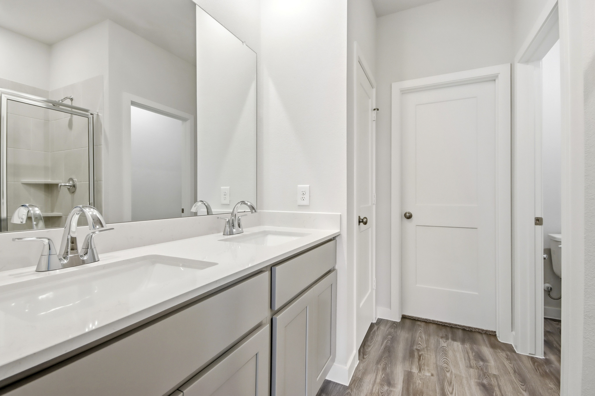 A bathroom with a large mirror.