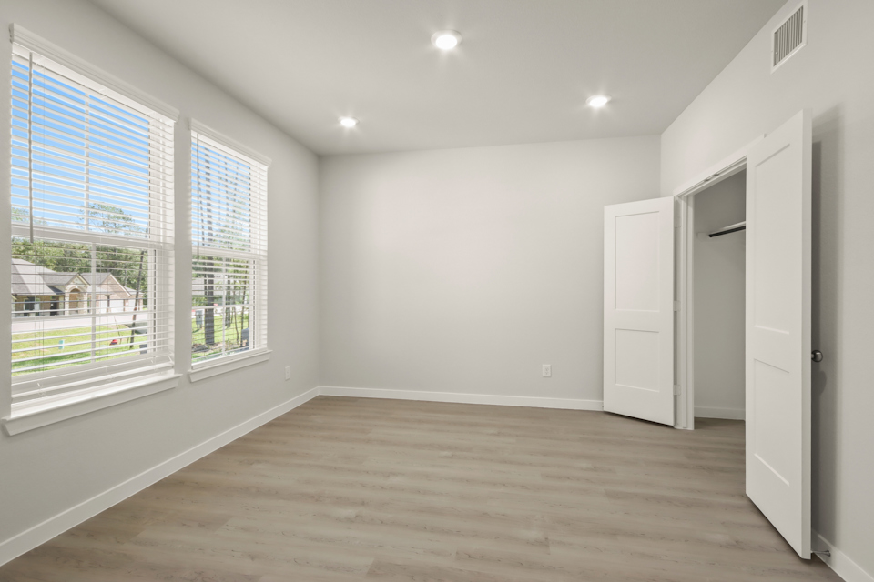 A room with a wood floor and white walls.
