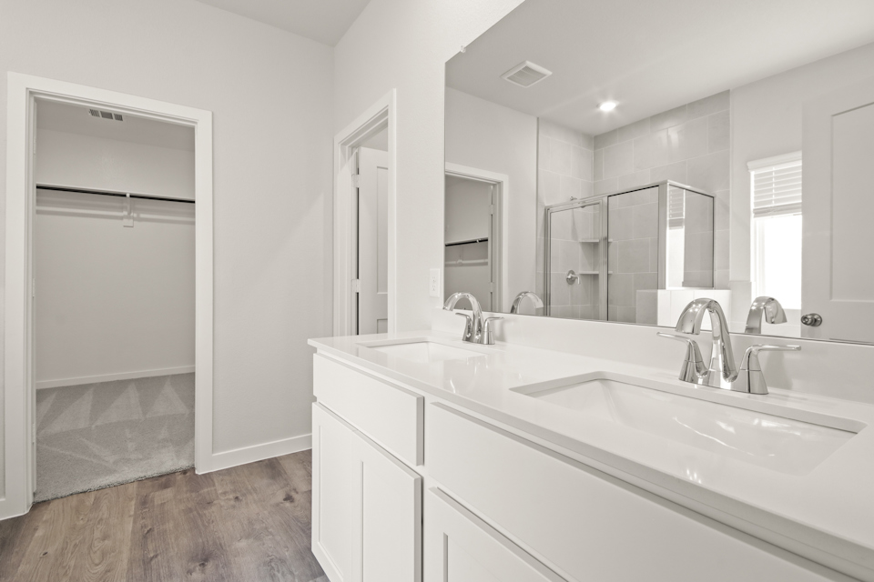 A bathroom with a large mirror.