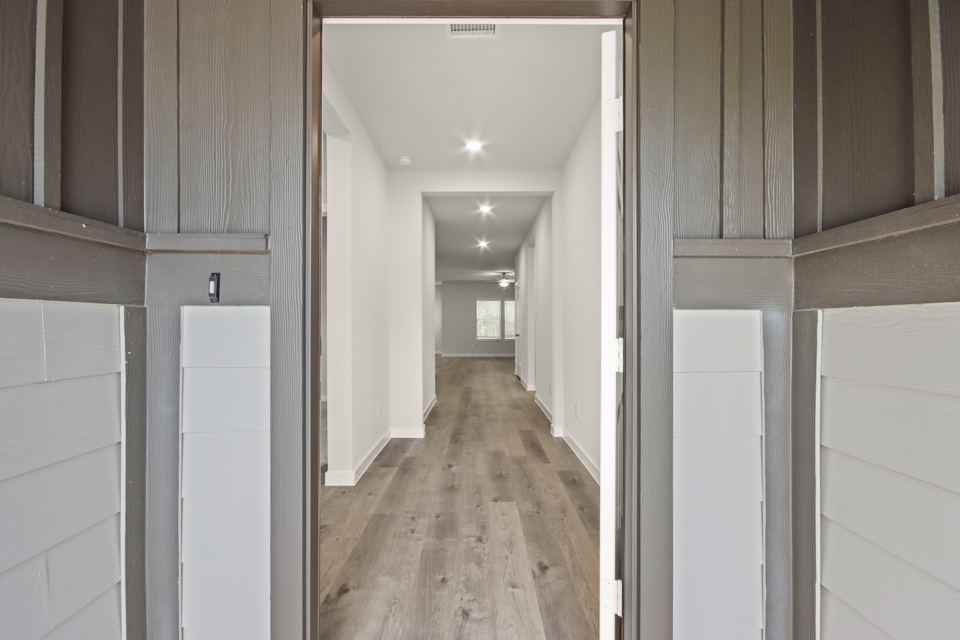 A hallway with white walls.