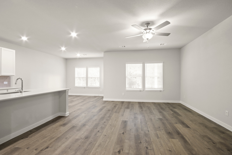 A kitchen with a wood floor.