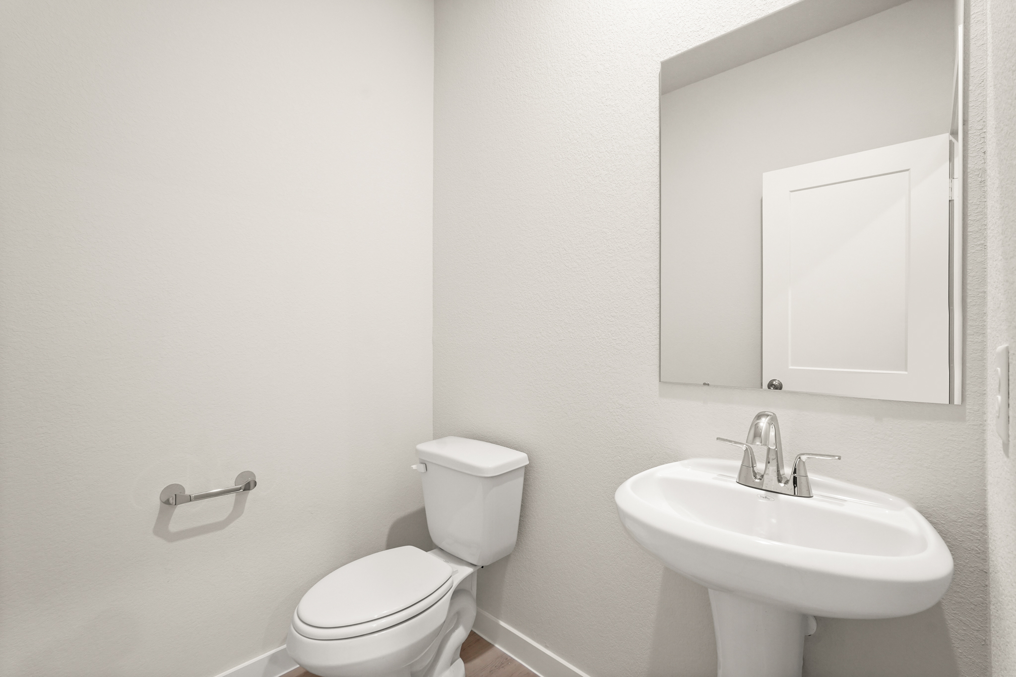 A bathroom with a toilet and sink.