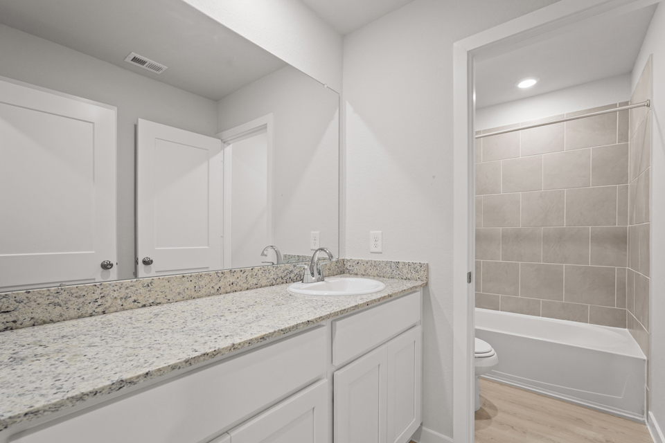 A bathroom with a marble countertop.