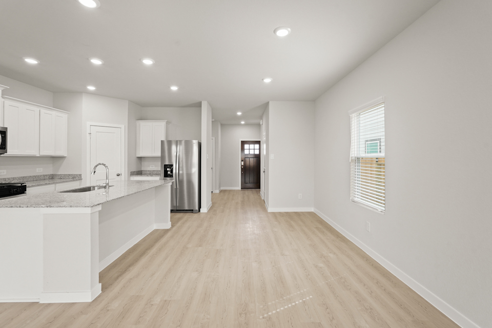 A kitchen with white cabinets.