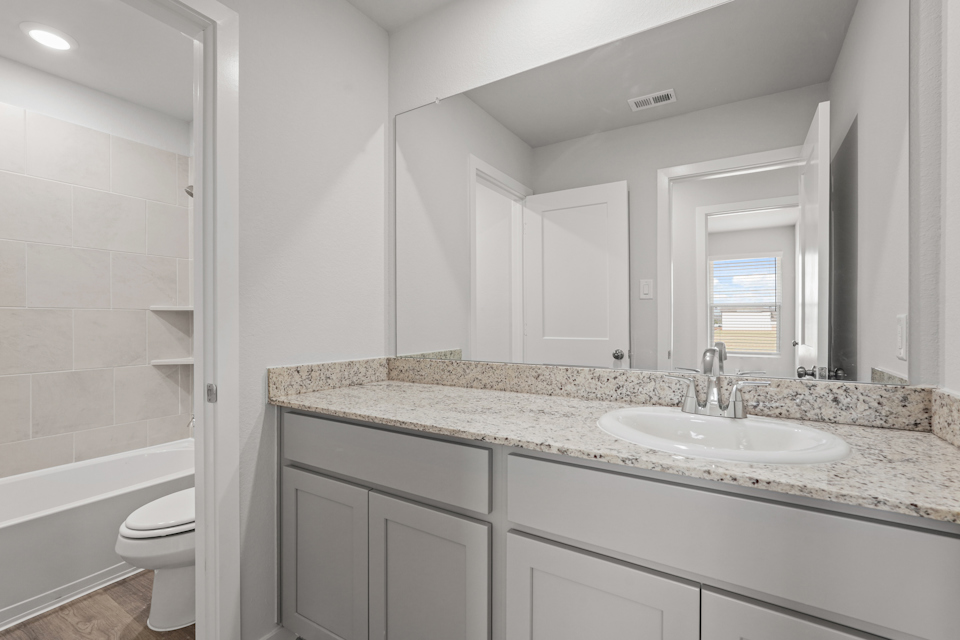 A bathroom with a marble countertop.