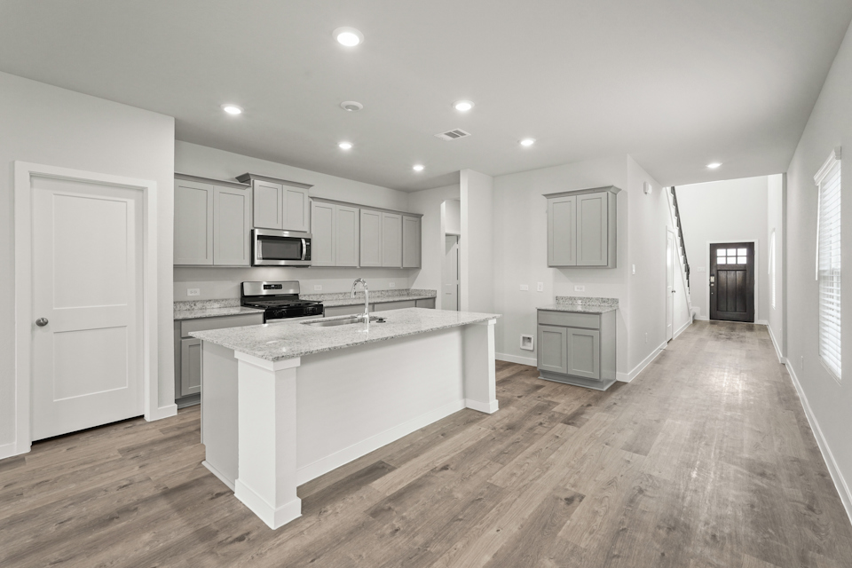 A kitchen with white cabinets.