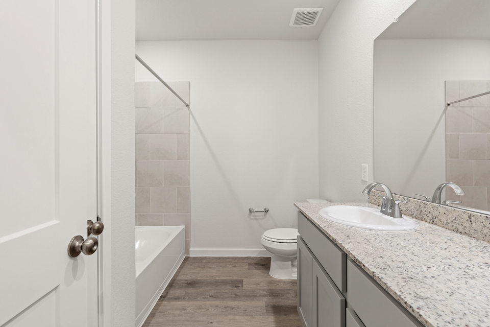 A bathroom with a marble countertop.