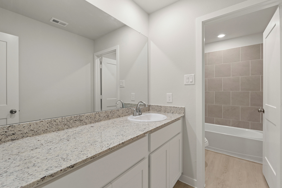 A bathroom with a marble countertop.