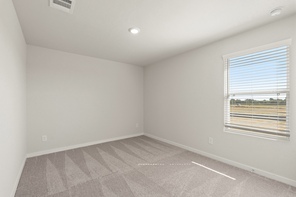 A room with a window and a tile floor.