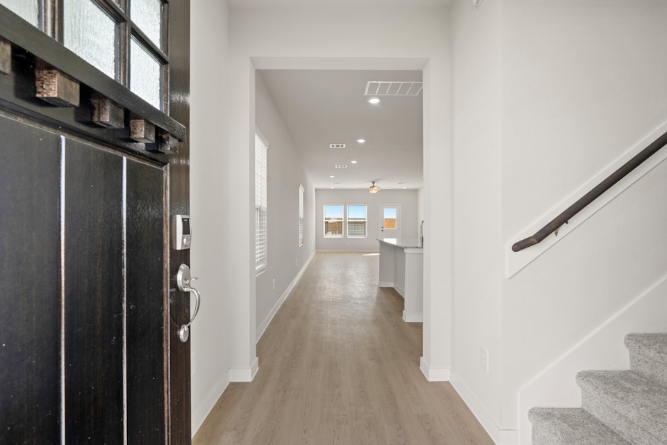 A hallway with white walls.
