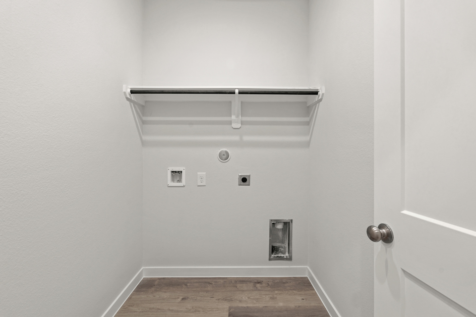 A white wall with a light fixture.