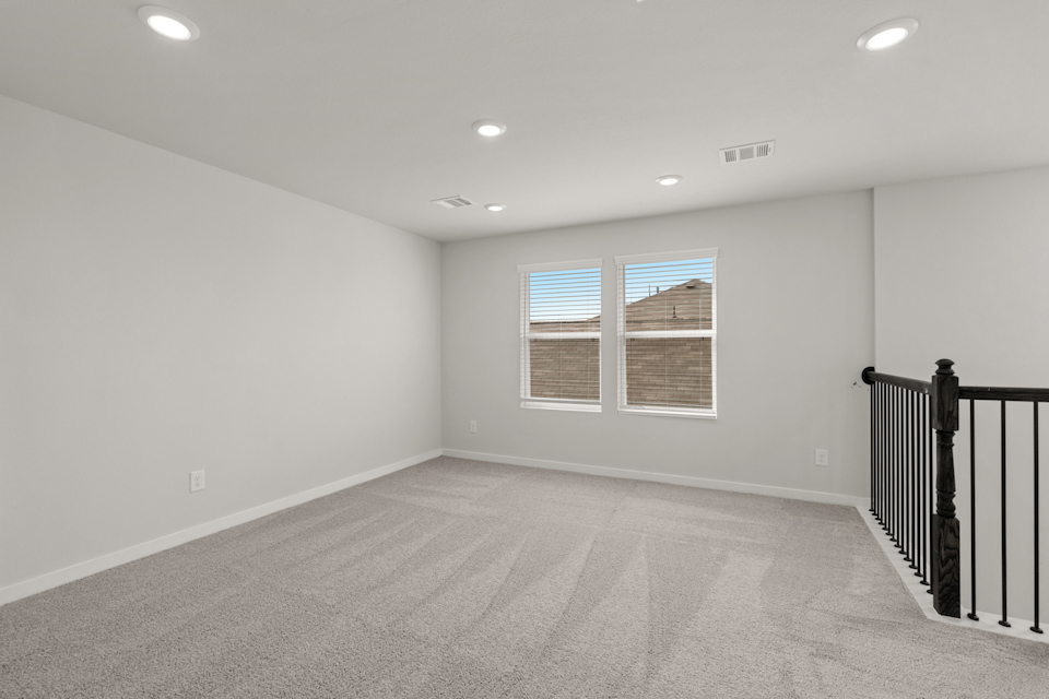 A room with a window and a railing.