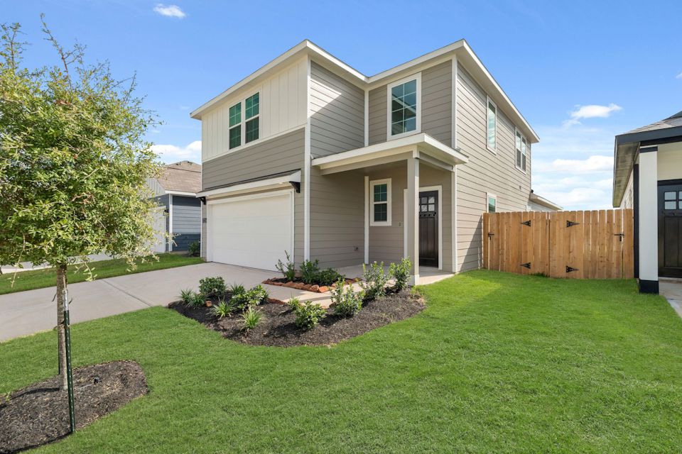 A house with a fence and yard.