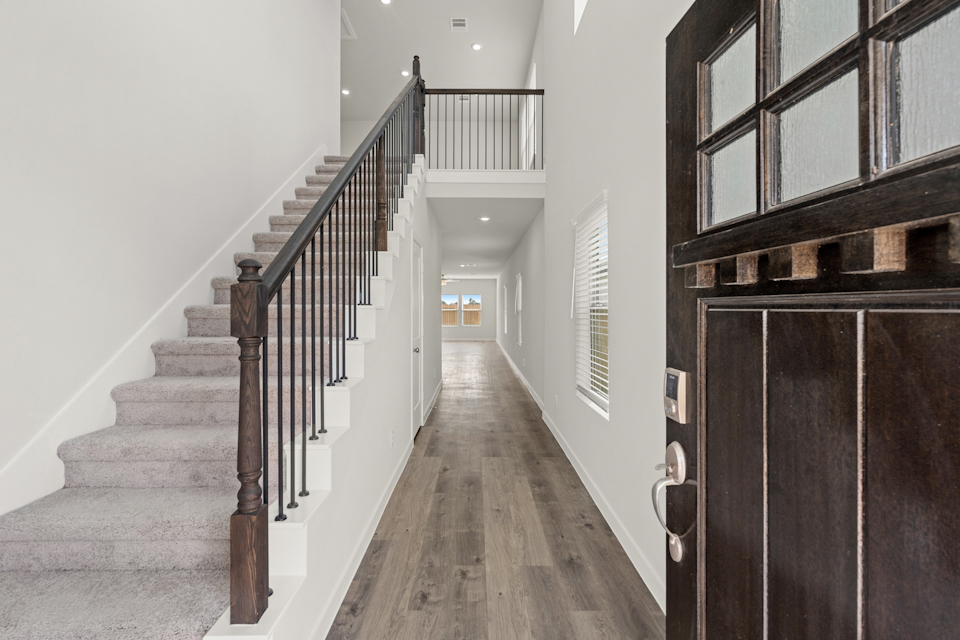 A long hallway with a wood railing.