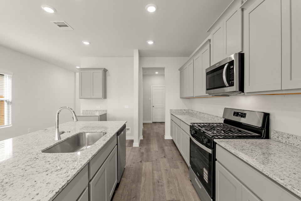 A kitchen with white cabinets.