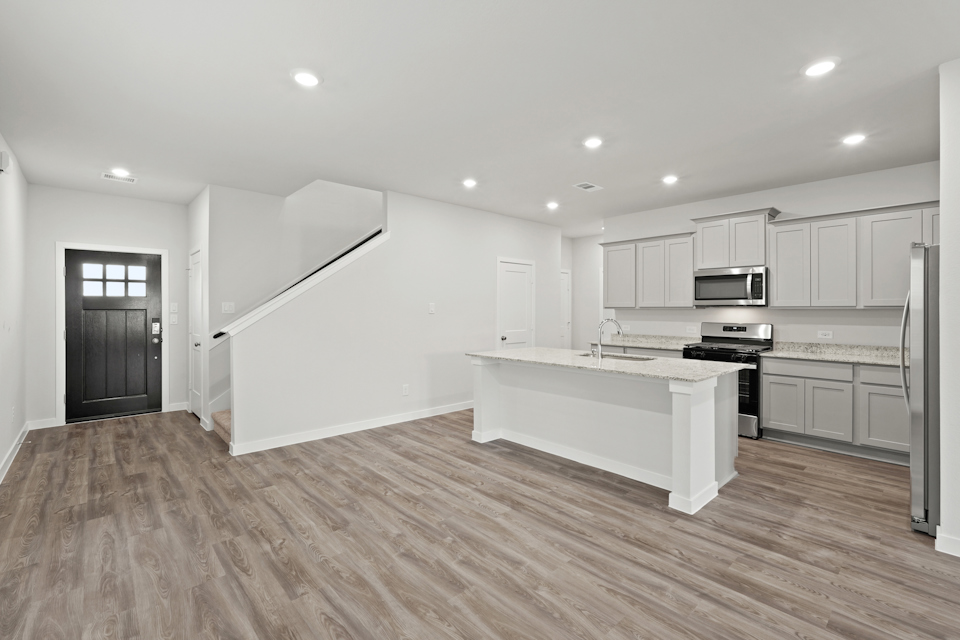 A kitchen with white cabinets.