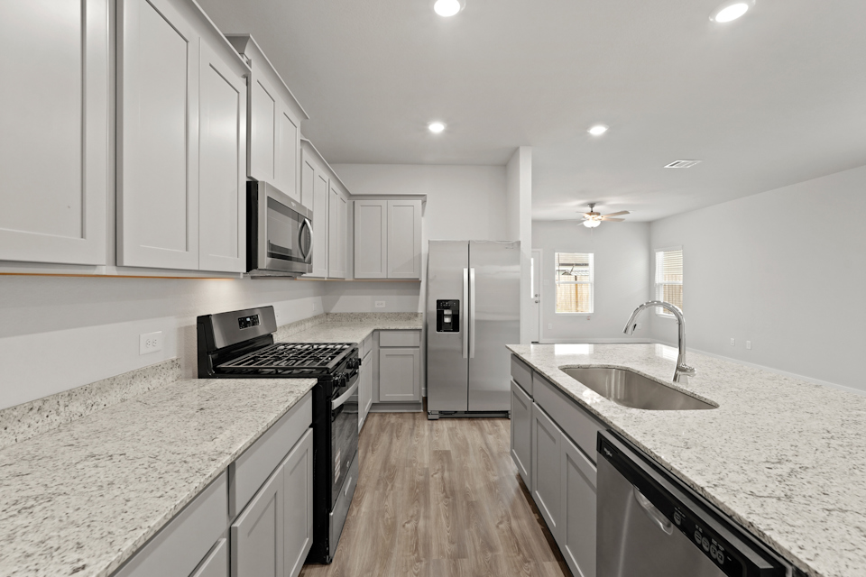 A kitchen with white cabinets.
