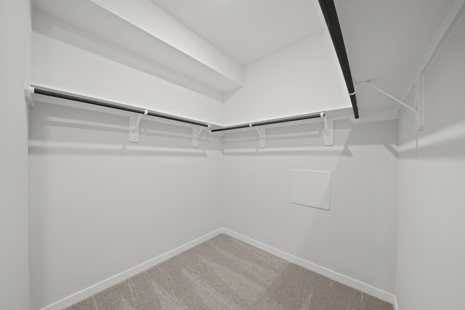 A white room with a carpet.