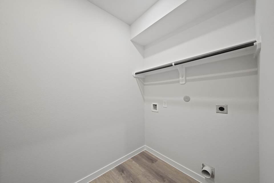 A white wall with a light fixture.