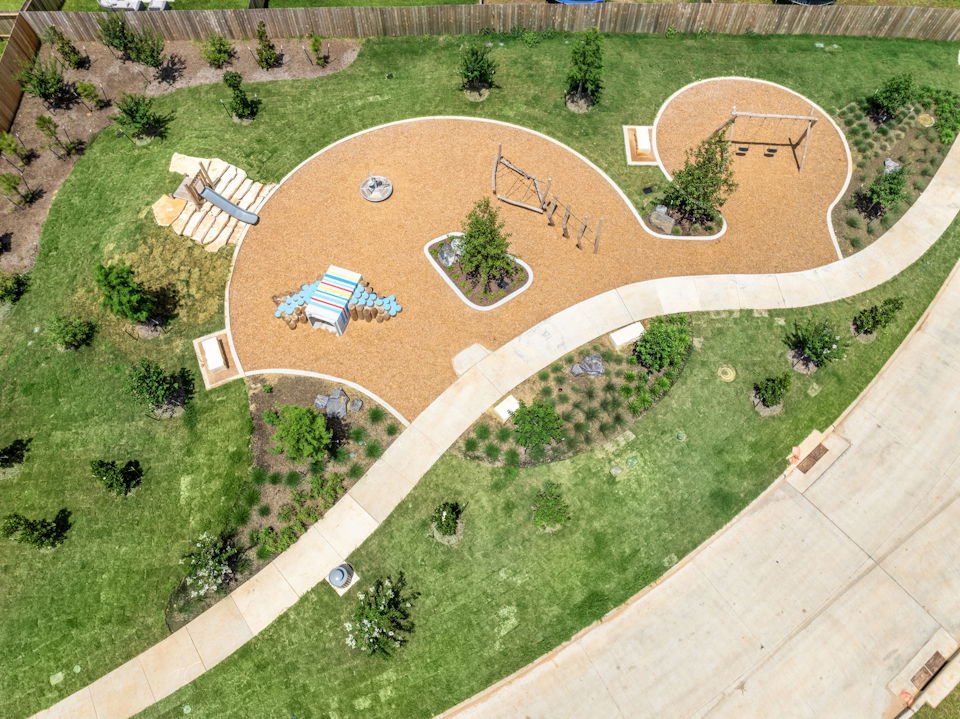 A large courtyard with a few buildings.