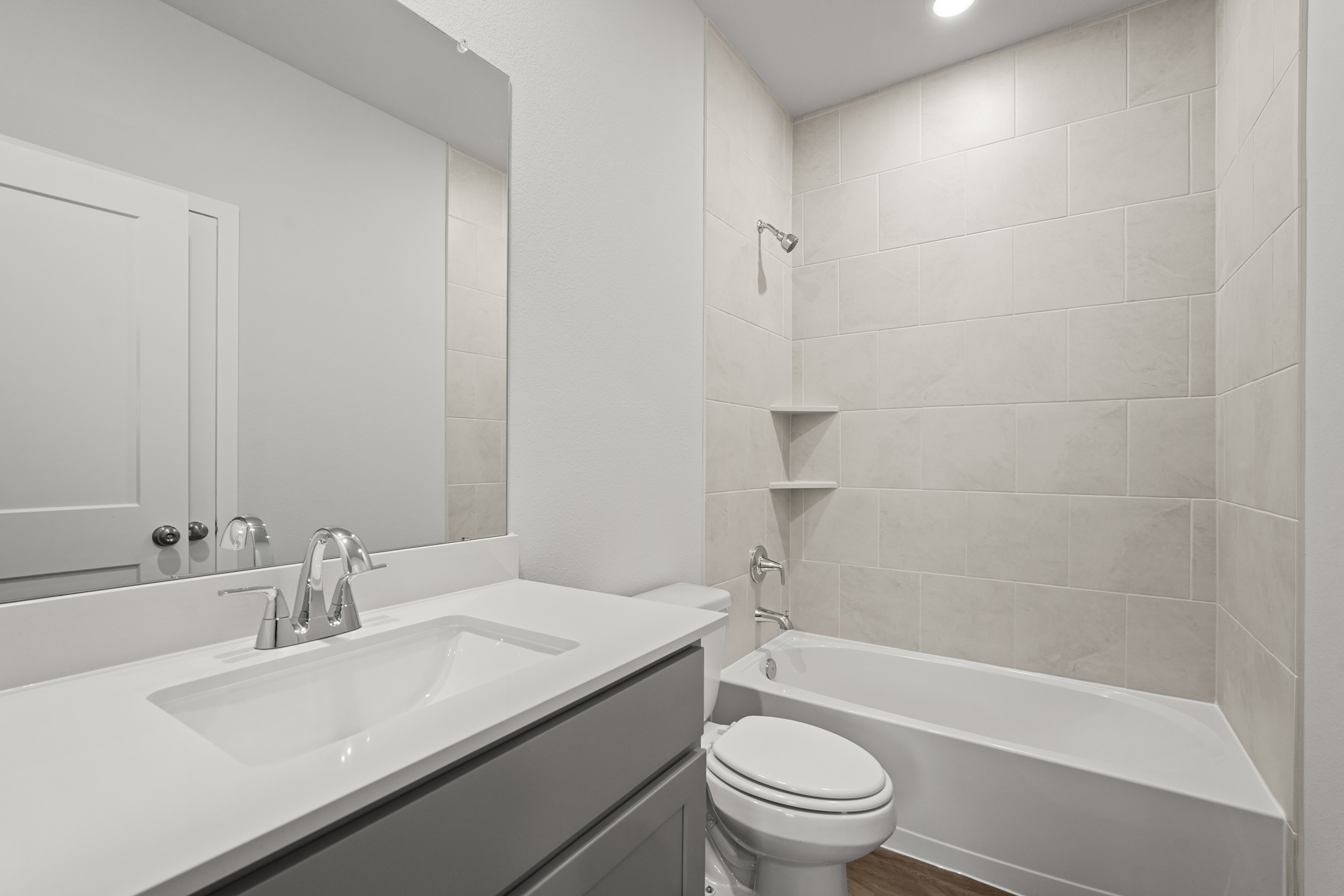 A bathroom with a tub sink and toilet.