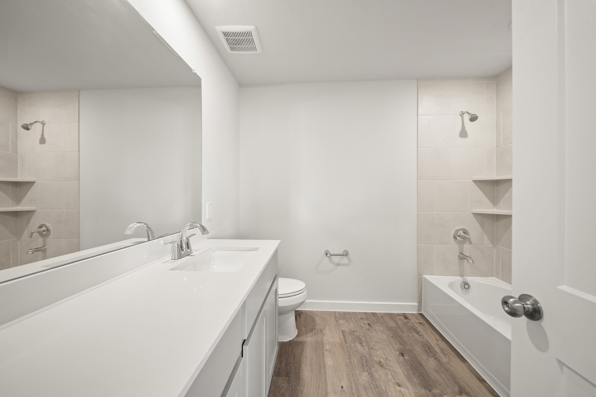 A bathroom with a tub toilet and sink.