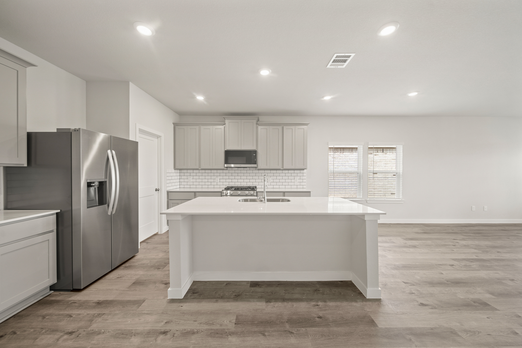 A kitchen with a large white counter.