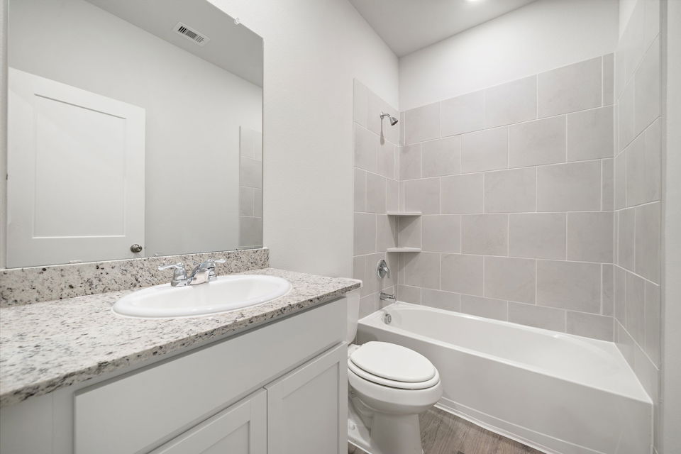 A bathroom with a sink and a toilet.
