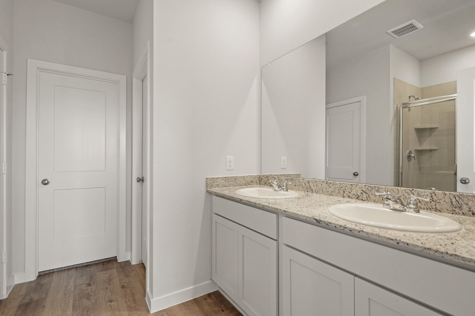 A bathroom with a large mirror.