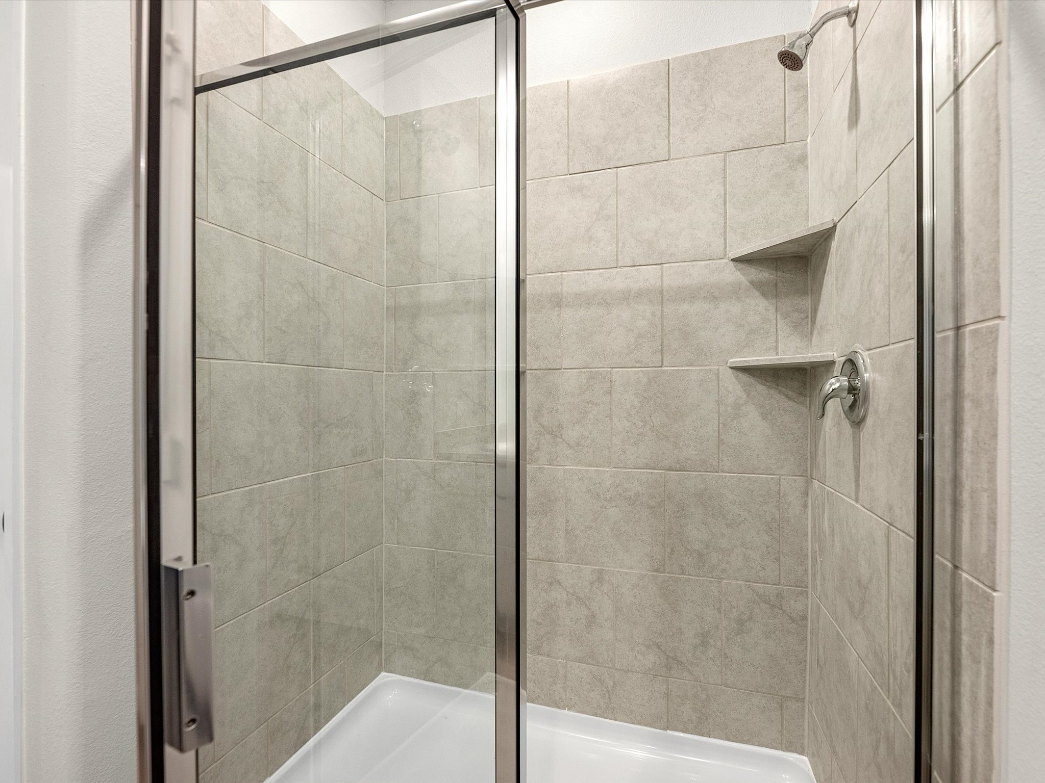 A shower with a glass door.