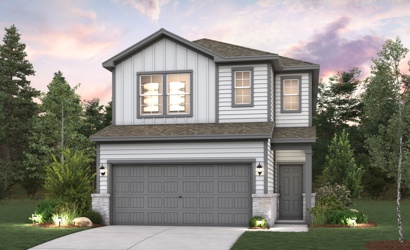 A house with a garage and trees around it.