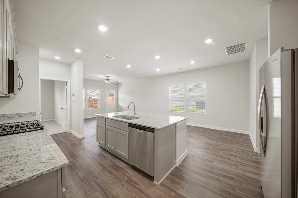 A kitchen with a marble island.