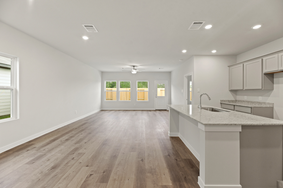 A kitchen with a wood floor.