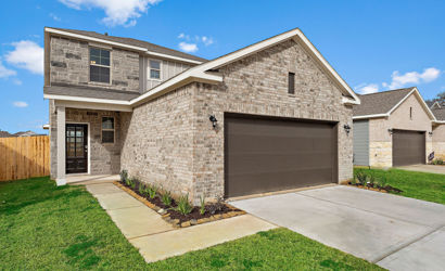 A stone house with a garage.