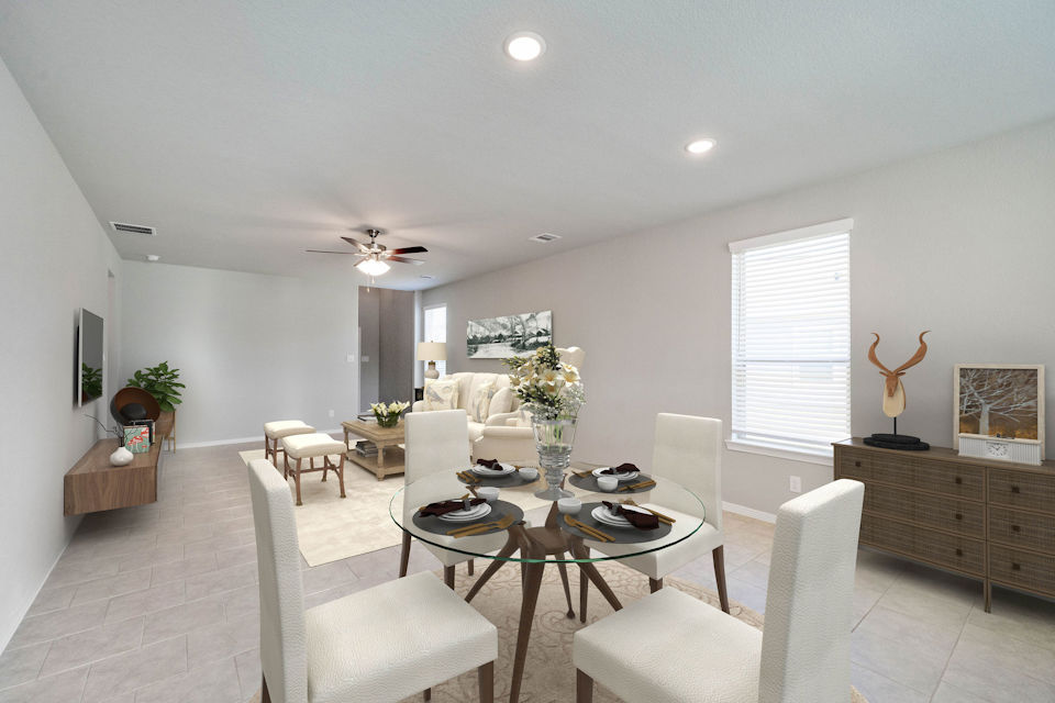 A living room with a table and chairs.