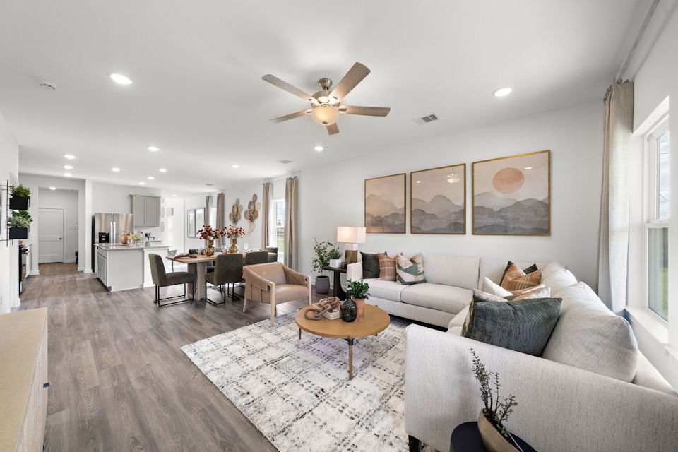 A living room with a chandelier and a couch.