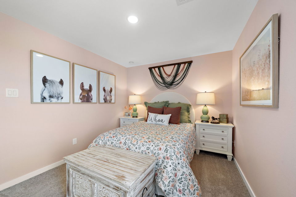 A bedroom with a bed and lamps.