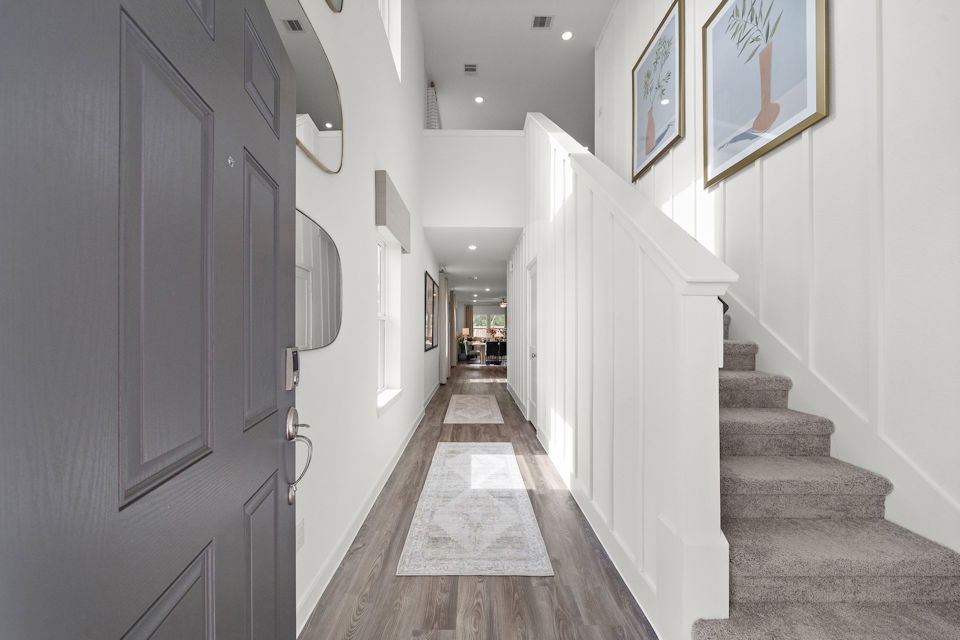 A hallway with white walls.