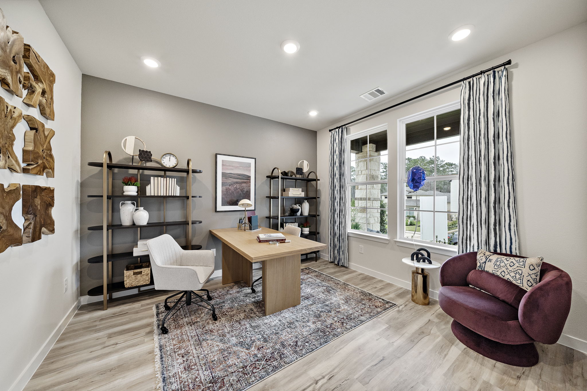 A living room with a table and chairs.