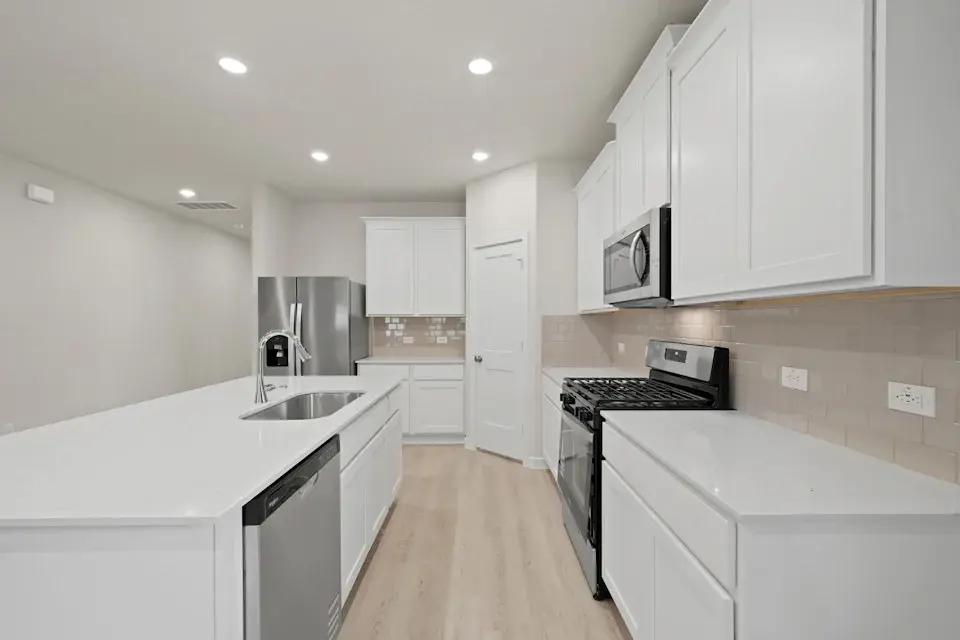 A kitchen with white cabinets.
