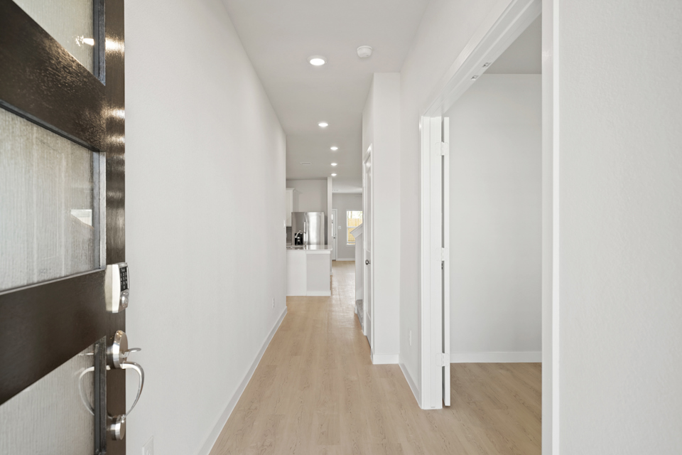 A hallway with white walls.