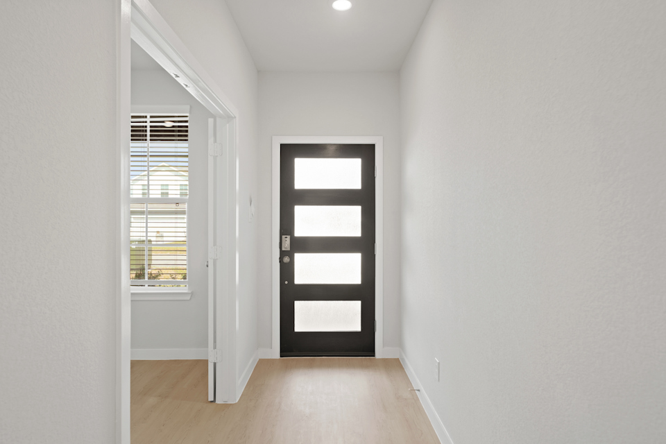 A room with white walls and a wood floor.