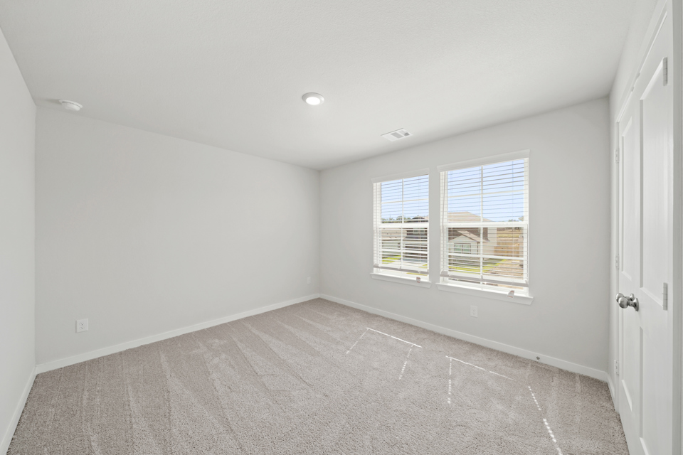 A room with a window and a door.