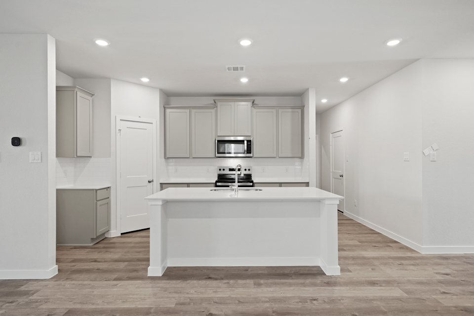 A kitchen with white cabinets.