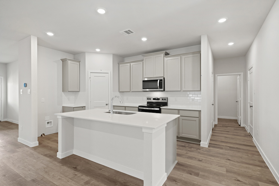 A kitchen with white cabinets.