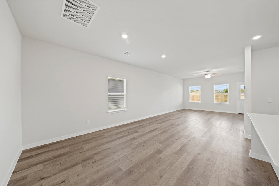 A room with a wood floor and white walls.