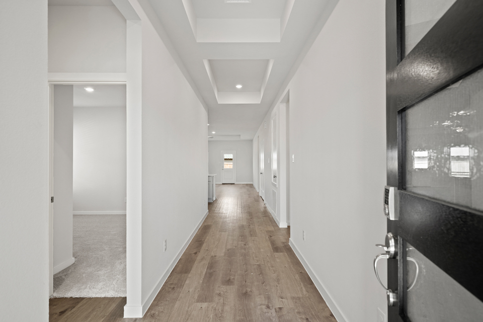 A hallway with white walls.