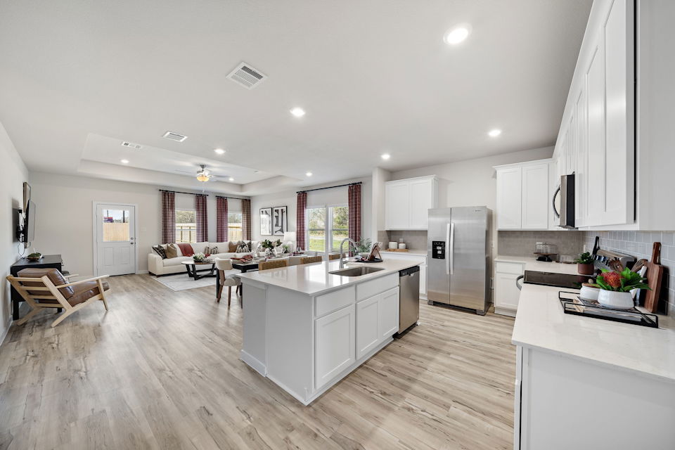 A kitchen with white cabinets.