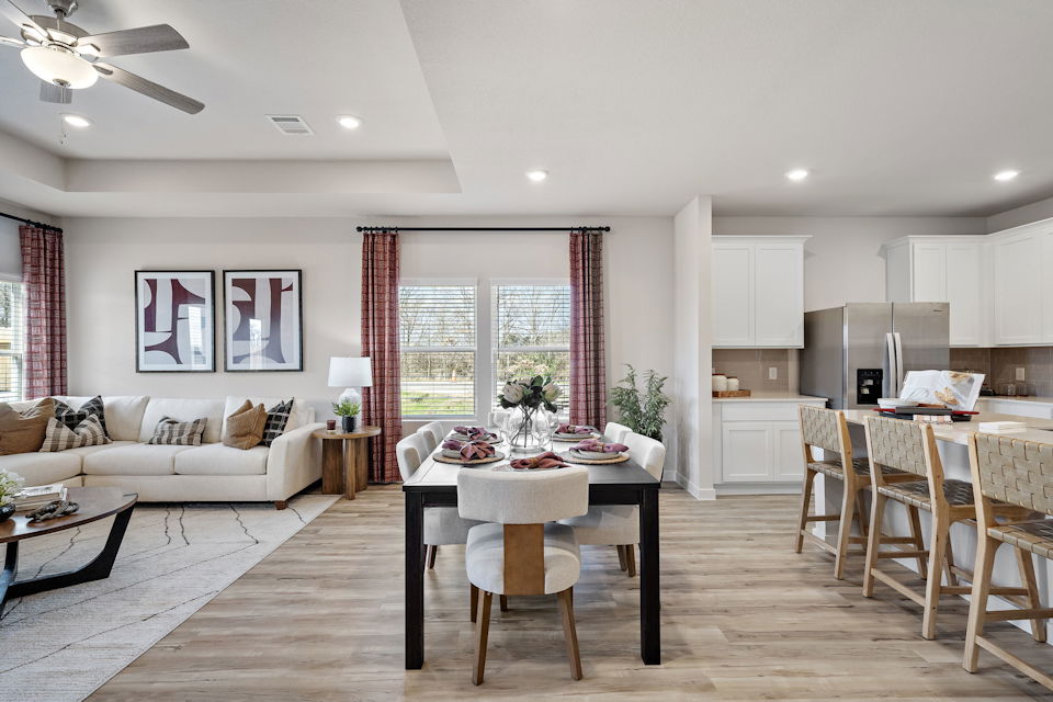 A large living room with a large table and chairs.