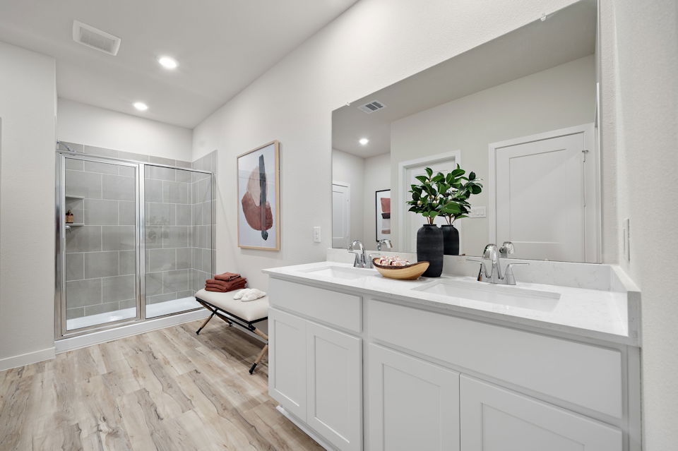 A bathroom with a sink and a shower.